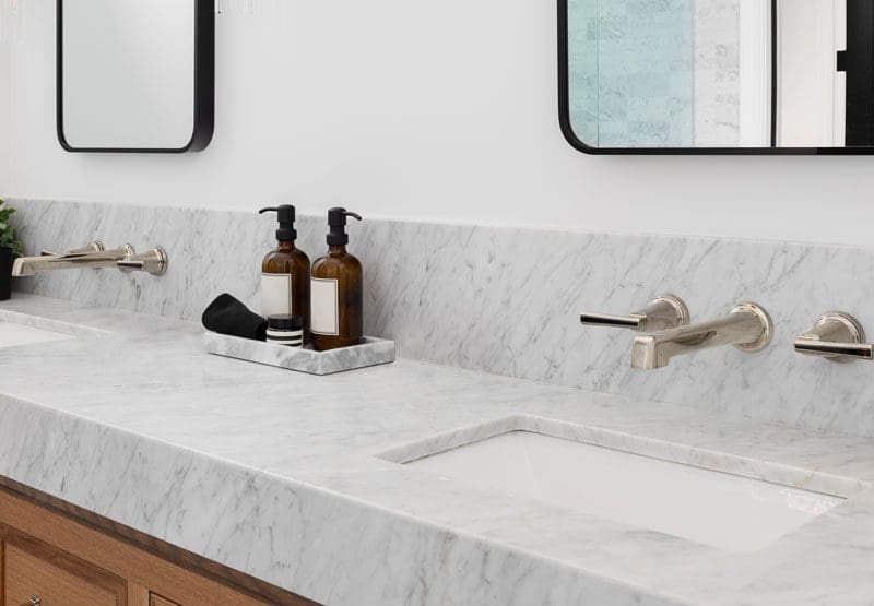 A dual sink light colored marble coutertop