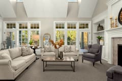 Beautiful living room in new traditional style luxury home. Features vaulted ceilings, fireplace and elegant furnishings.